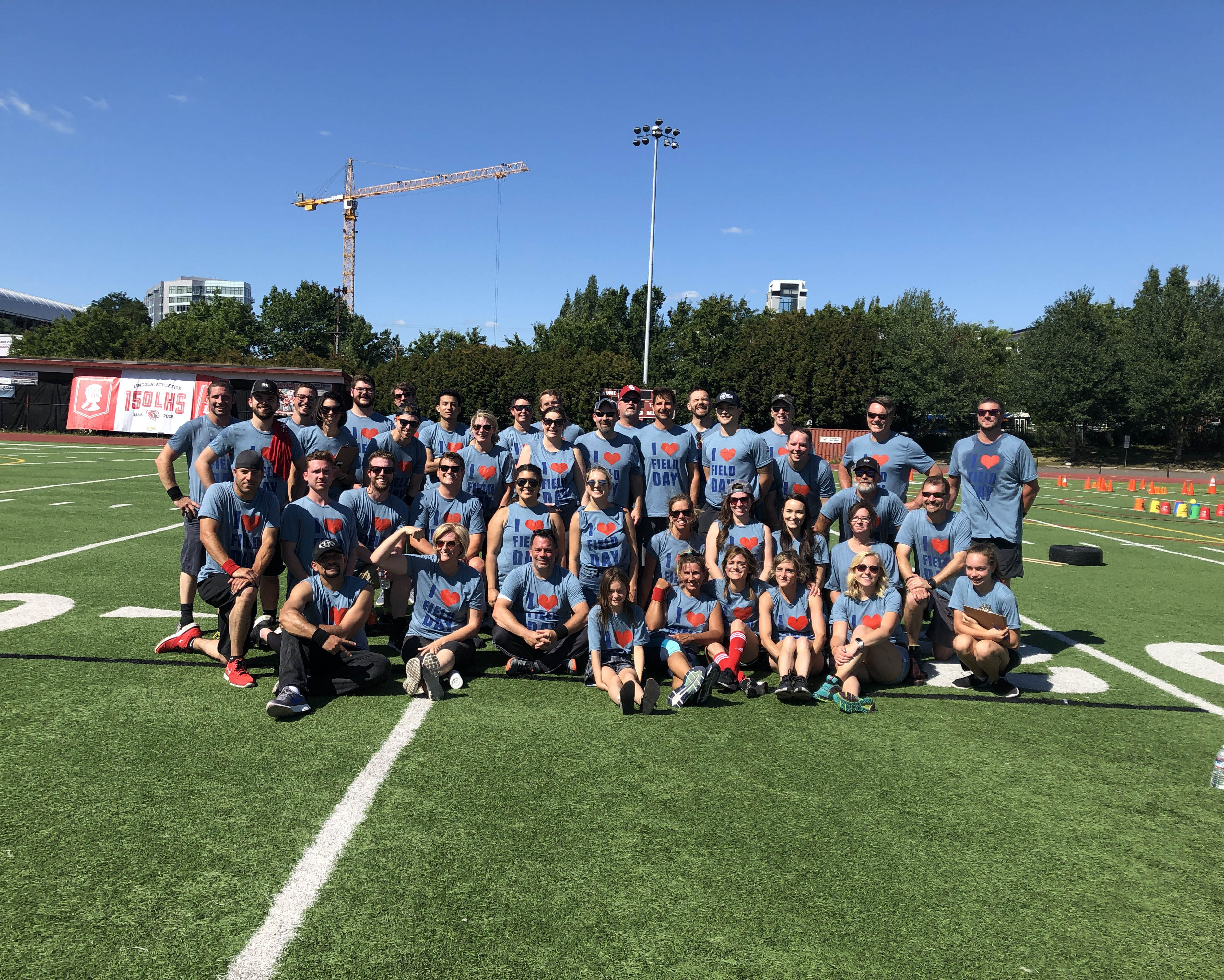 Group shot of R&H employees on football field for field day