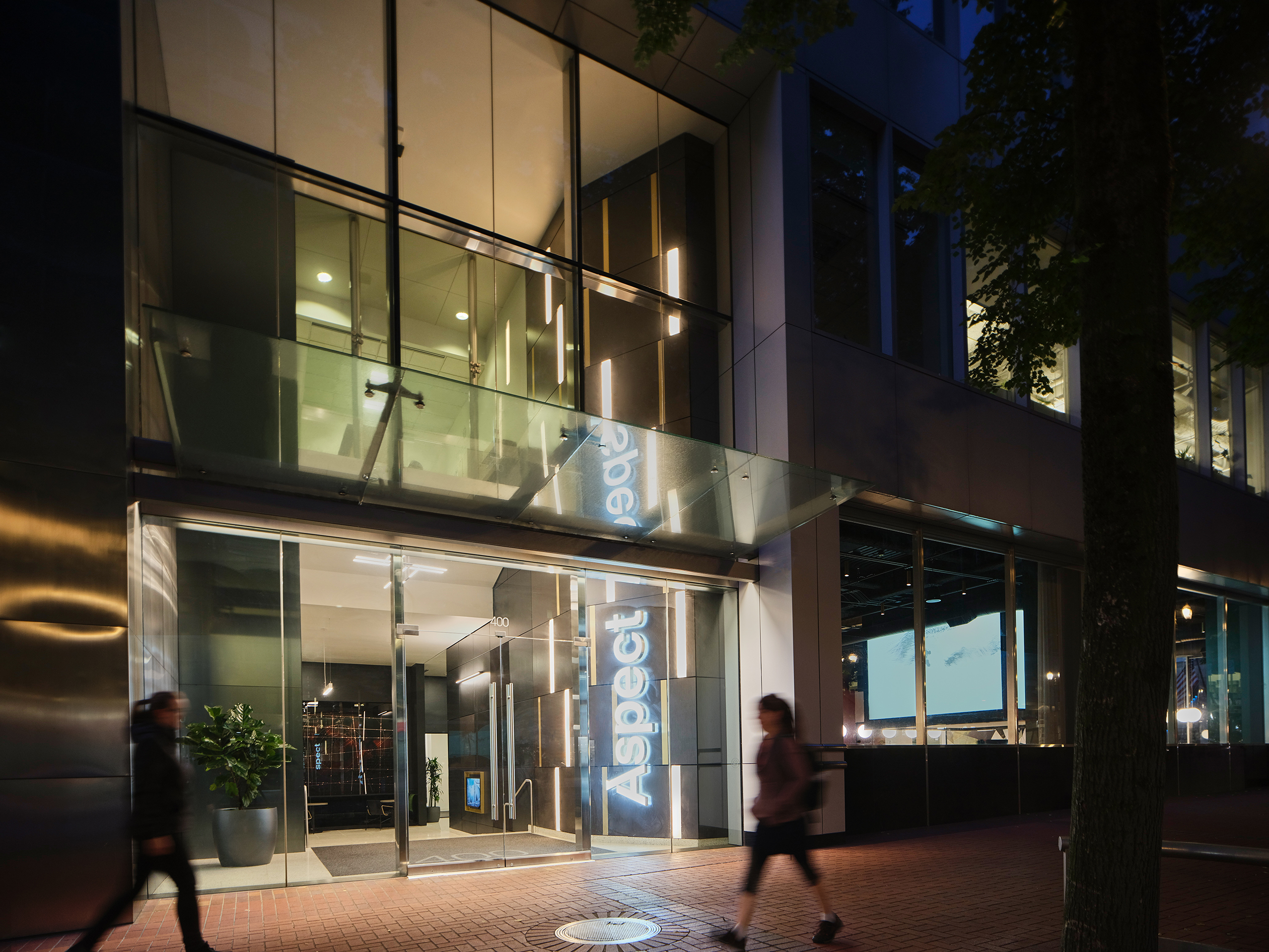 exterior of Aspect from the street at night, focus on LED logo signage